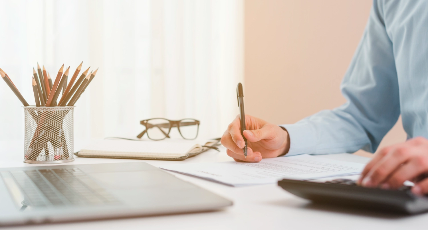 Open notebook and pen beside estate planning documents on a calm, organized desk in soft natural light